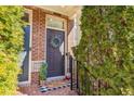 Inviting front entrance with a welcoming wreath, charming decor, and a brick-paved walkway at 7420 Glisten Ave, Sandy Springs, GA 30328