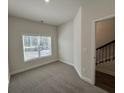 A carpeted room featuring a window with natural light at 5455 Blossomwood Sw Trl, Mableton, GA 30126