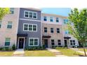 View showcasing the townhouses with their well-kept lawns at 5455 Blossomwood Sw Trl, Mableton, GA 30126