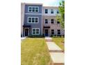 Exterior view showcasing the townhouses, front yards, and walkways at 5455 Blossomwood Sw Trl, Mableton, GA 30126