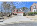 Expansive driveway leads to a beautiful brick home with a two-car attached garage at 3743 Heathermoor Ct, Dacula, GA 30019