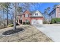 Well-manicured lawn leads to a beautiful brick home with attached two-car garage at 3743 Heathermoor Ct, Dacula, GA 30019