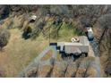 Expansive property featuring a well-maintained home, long driveway and large lawn at 8321 Banks Mill Rd, Douglasville, GA 30135