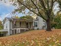 Charming home with a covered porch, classic stonework, and mature landscaping at 8321 Banks Mill Rd, Douglasville, GA 30135
