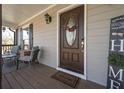 Inviting front porch with a decorative wreath and cozy seating area at 8321 Banks Mill Rd, Douglasville, GA 30135