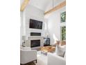 Beautiful living room with fireplace, bright white interior, and comfortable seating at 1290 Lupo Loop, Chattahoochee Hills, GA 30268