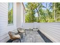 Cozy outdoor patio with seating, neutral colors, and serene backyard view at 1290 Lupo Loop, Chattahoochee Hills, GA 30268