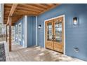 Beautiful front porch featuring a wooden beam ceiling and a stylish front door at 474 Maxwell Rd, Roswell, GA 30075