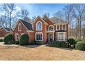 Classic brick home with mature trees and manicured shrubs in the front yard at 1290 Regency Center Sw Dr, Atlanta, GA 30331