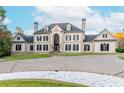 Beautifully designed home with a spacious front yard, circular driveway, and well-manicured landscaping at 1806 Wynthrop Manor Sw Dr, Marietta, GA 30064