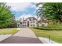 Stately home with a long driveway, lush lawn, and mature trees creating a serene and private setting at 1806 Wynthrop Manor Sw Dr, Marietta, GA 30064