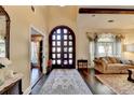 Elegant foyer featuring a grand arched doorway, hardwood floors, and sophisticated decor at 5180 Cameron Forest Pkwy, Johns Creek, GA 30022