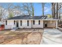Inviting one-story home showcasing a covered carport and freshly painted exterior at 2867 Mitchell Dr, Decatur, GA 30032