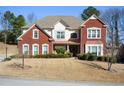 Charming two-story home with a manicured lawn and brick and stucco facade at 6026 Southland Dr, Stone Mountain, GA 30087