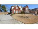 Exterior view of a two-story home with a long driveway at 6026 Southland Dr, Stone Mountain, GA 30087