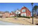 A brick and stucco two-story house is located in a residential neighborhood at 6026 Southland Dr, Stone Mountain, GA 30087