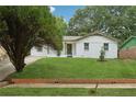 Landscaped front yard with healthy lawn complements the charming single-story home at 2005 Simmons Ave, Atlanta, GA 30337