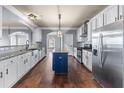 Modern kitchen with white cabinets, granite countertops, stainless steel appliances, and hardwood floors at 5170 Black Bear Trl, Douglasville, GA 30135