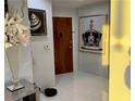 Inviting hallway with white tiled floors and decorative artwork at 361 17Th Nw St # 2423, Atlanta, GA 30363
