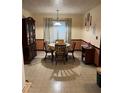 A dining room area with beige and peach walls and outdated flooring at 5581 Shadow Rock Dr, Lithonia, GA 30058
