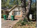Cozy single story exterior with stone and siding, a few trees, and driveway at 5581 Shadow Rock Dr, Lithonia, GA 30058