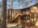 Condo exterior featuring painted wood finishes and wooden staircases leading to upper-level entry at 5780 Par Four Ct, Lithonia, GA 30038