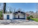 Spacious carport featuring room for two vehicles with an attached storage room at 355 Ridgeview Trl, Atlanta, GA 30328