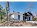 View of the side of the house featuring a carport and storage room with two separate entrances at 355 Ridgeview Trl, Atlanta, GA 30328