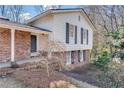 Multi-level home featuring a mix of brick and siding, complemented by mature landscaping at 355 Ridgeview Trl, Atlanta, GA 30328