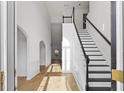 Bright foyer with hardwood floors and elegant staircase creating an inviting atmosphere at 1471 Adair Hill Ct, Dacula, GA 30019