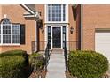 A welcoming front entryway with a black front door and meticulously maintained landscaping at 1471 Adair Hill Ct, Dacula, GA 30019