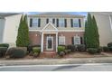 Attractive townhouse boasting brick facade, manicured bushes, and black shutters at 3272 Tiara Sw Cir, Atlanta, GA 30311