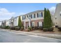 Inviting two-story townhouse showcasing well-kept landscaping and black shutters at 3272 Tiara Sw Cir, Atlanta, GA 30311