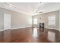 Bright living room featuring hardwood floors, fireplace, and large windows for plenty of sunlight at 3272 Tiara Sw Cir, Atlanta, GA 30311