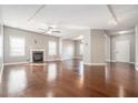 Spacious living room with hardwood floors, fireplace, ample natural light, and neutral paint at 3272 Tiara Sw Cir, Atlanta, GA 30311