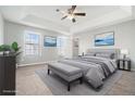 Comfortable main bedroom with tray ceiling, carpet flooring, and bright, neutral paint at 3272 Tiara Sw Cir, Atlanta, GA 30311