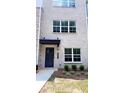 Townhouse exterior with attractive front door, neat landscaping, and classic brick facade at 5447 Blossomwood Sw Trl, Mableton, GA 30126