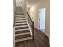Elegant staircase featuring wood and white trim, leading to the upper level at 5447 Blossomwood Sw Trl, Mableton, GA 30126