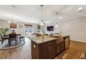 An open-concept kitchen features a granite island, stainless steel appliances, and a dining area at 599 Collections Dr, Lawrenceville, GA 30043