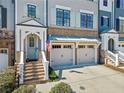 Lovely townhome showcasing a two-car garage and well-manicured landscaping at 244 Trecastle Sq, Canton, GA 30114