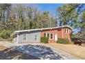 Classic brick home with a gray accent wall and a manicured front lawn, perfect for enjoying suburban living at 3035 Mclendon Nw Cir, Atlanta, GA 30318