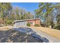 Inviting home with a long driveway and well-kept lawn, ideal for outdoor activities and entertaining guests at 3035 Mclendon Nw Cir, Atlanta, GA 30318