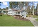 Charming two-story home with attached garage and lush green lawn at 322 Foxfire Sw Dr, Smyrna, GA 30082