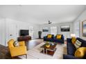 Bright living room featuring hardwood floors, neutral walls, stylish furniture, and natural lighting at 3280 Hazelwood Sw Dr, Atlanta, GA 30311
