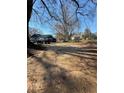 A home with a long driveway and ample parking, surrounded by trees at 3814 Rex Rd, Rex, GA 30273