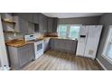 Modern kitchen features gray cabinets, new appliances, and light wood countertops at 3814 Rex Rd, Rex, GA 30273