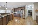 Modern kitchen featuring stainless steel appliances, custom cabinetry, and beautiful granite countertops with hardwood floors at 2139 Golden Morning Ct, Kennesaw, GA 30152