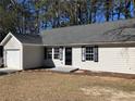 A well-maintained single-story home showcasing neutral siding, and a cozy front entrance at 2678 Brook Park Way, Atlanta, GA 30340