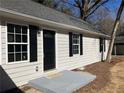 Close-up of the front entrance featuring a black door and matching shutters on a charming home at 2678 Brook Park Way, Atlanta, GA 30340
