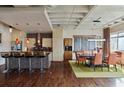 Stylish kitchen with modern appliances, a tile backsplash, and bar seating flowing into the dining area at 805 Peachtree Ne St # 614, Atlanta, GA 30308